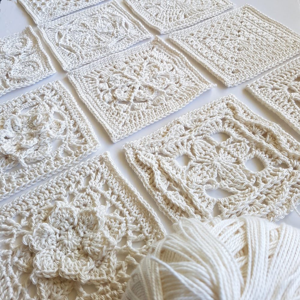 10 granny squares in cream from Granny Square Flair by Shelley Husband with a ball of cream yarn