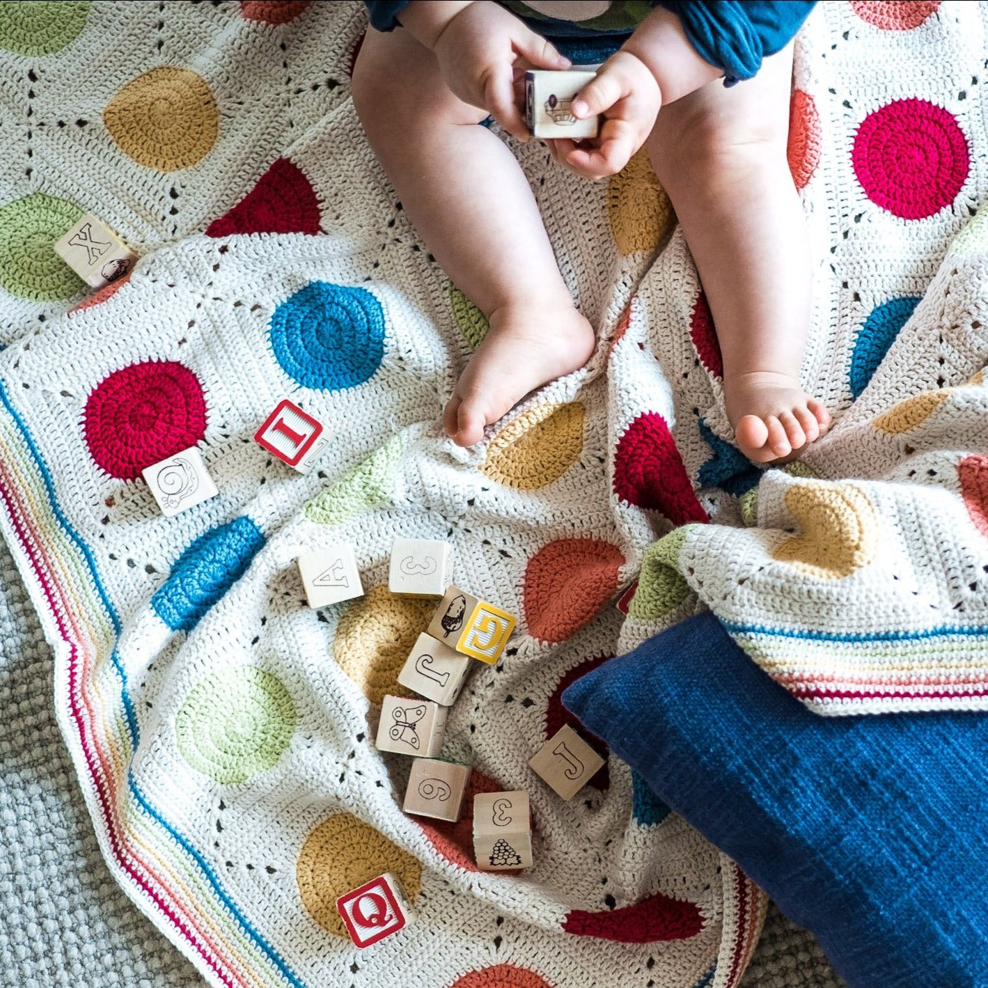 Baby on a blanket from Granny Square Flair by Shelley Husband