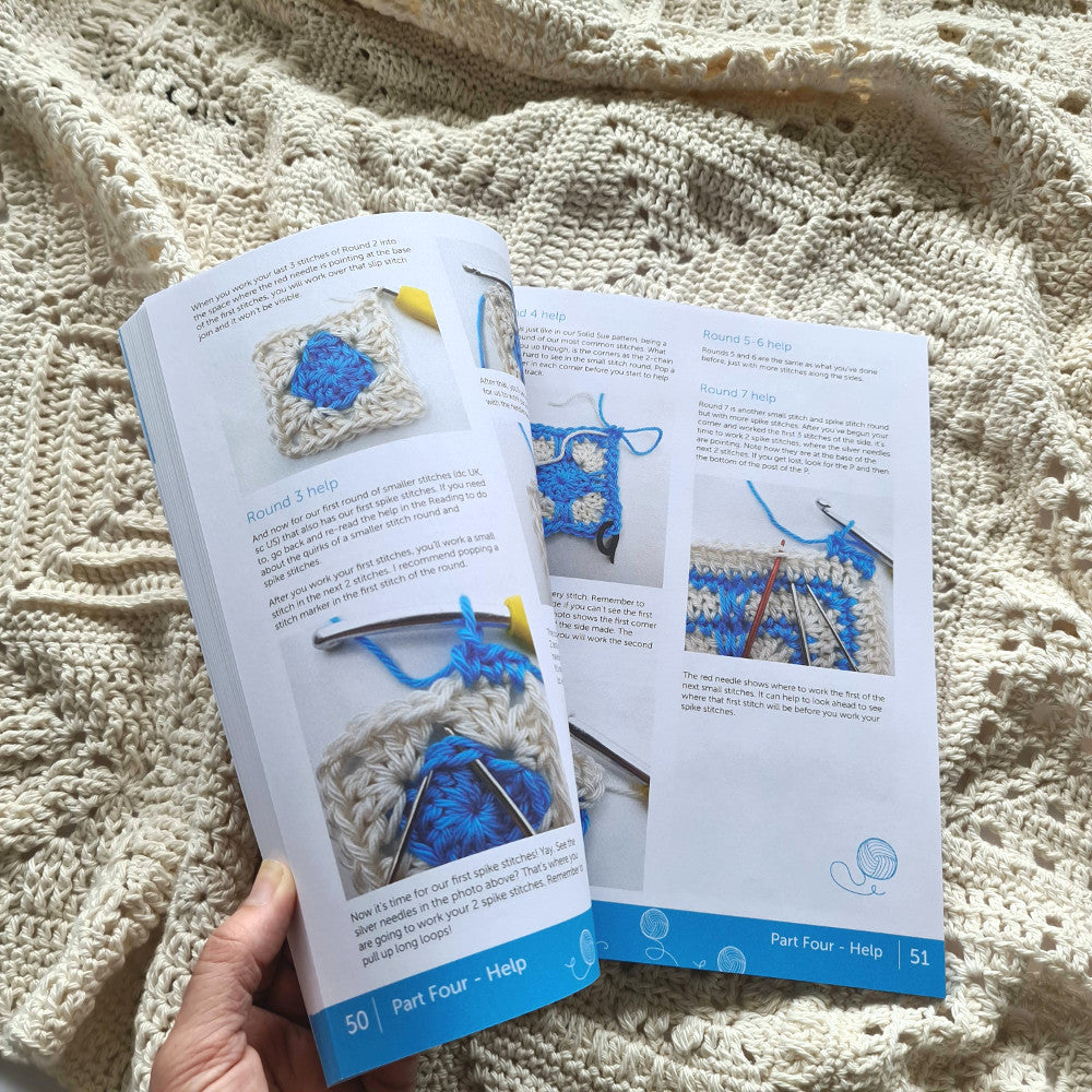 Hand flicking through a Granny Square Academy book on a Granny Square Academy sampler blanket