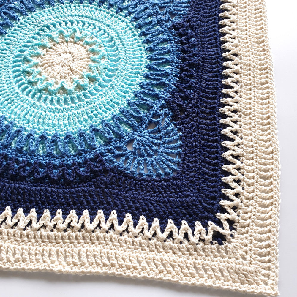 Close up of Hope large granny square pattern in blues and cream by Shelley Husband
