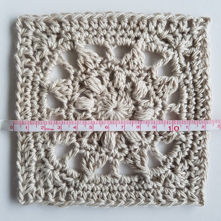 Mayan Mini Taster pattern granny square by Shelley Husband with a tape measure over it measuring 12 inches