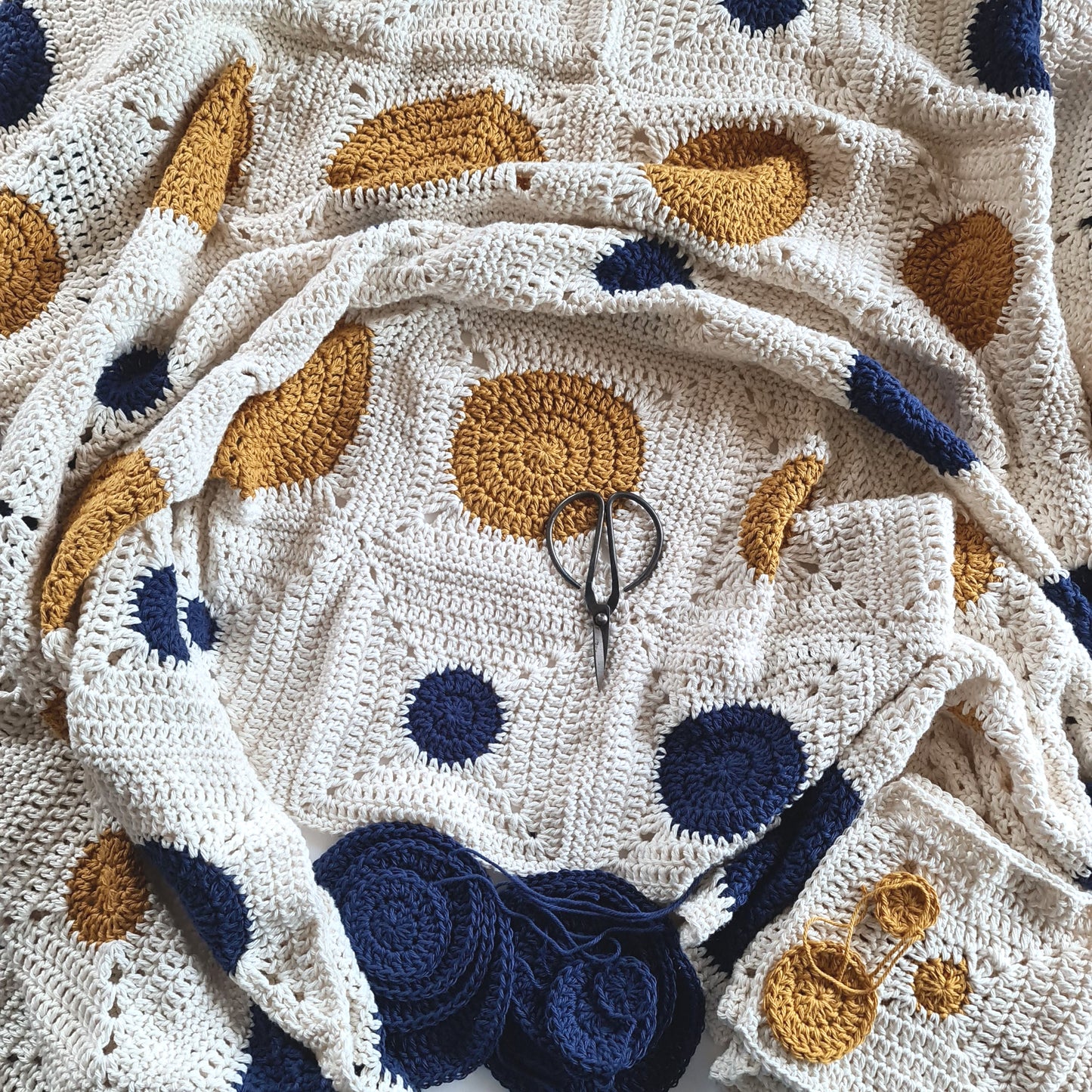 Mostly complete Dotty Spotty Blanket with some loose circles waiting to become granny squares.