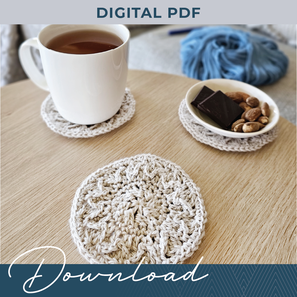 Three crochet coasters on a timber coffee table, the two towards the back have a coffee cup and a small dish of snacks on them.