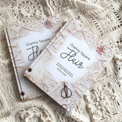 Granny Square Flair hardcover books by Shelley Husband on a cream sampler blanket