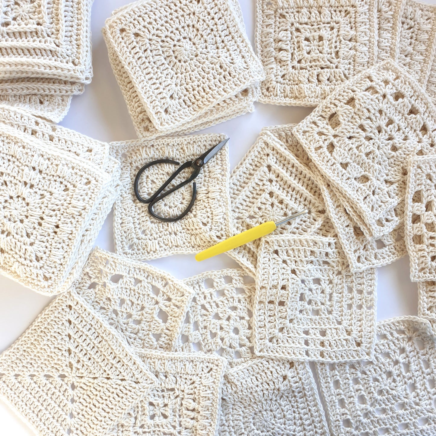 Granny Squares from Granny Square Academy by Shelley Husband with a yellow handled silver crochet hook and a pair of black yarn scissors