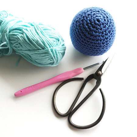 a blue ball, mint yarn, a pink handled crochet hook and a pair of black yarn scissorsIntro to amigurumi by Shelley Husband