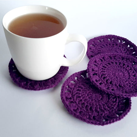 Chrissy's Coasters Pattern by Shelley Husband purple coasters with a cup of tea on the left one