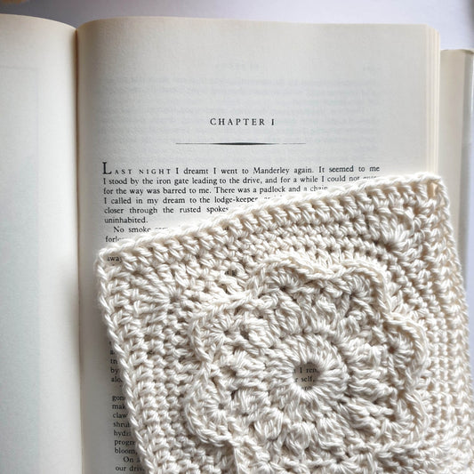 Granny square from Manderley Crochet Blanket Taster Pattern by Shelley Husband over the first page of Rebecca book