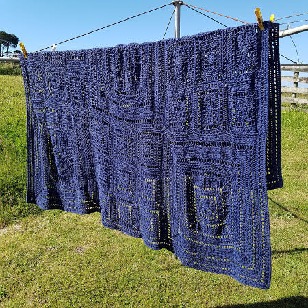 Fran Crochet Blanket Pattern by Shelley Husband in blue on clothes line