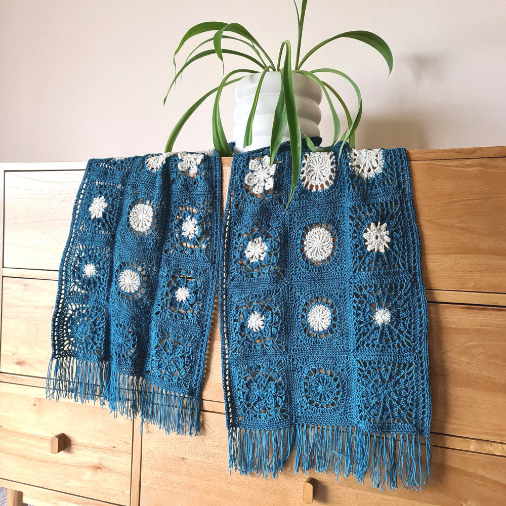 Frosty Flair Scarf Project on a console with a plant by Shelley Husband