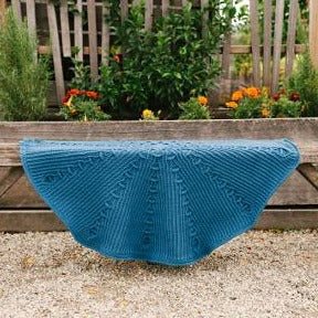 Millpond blanket by Shelley Husband over a bench