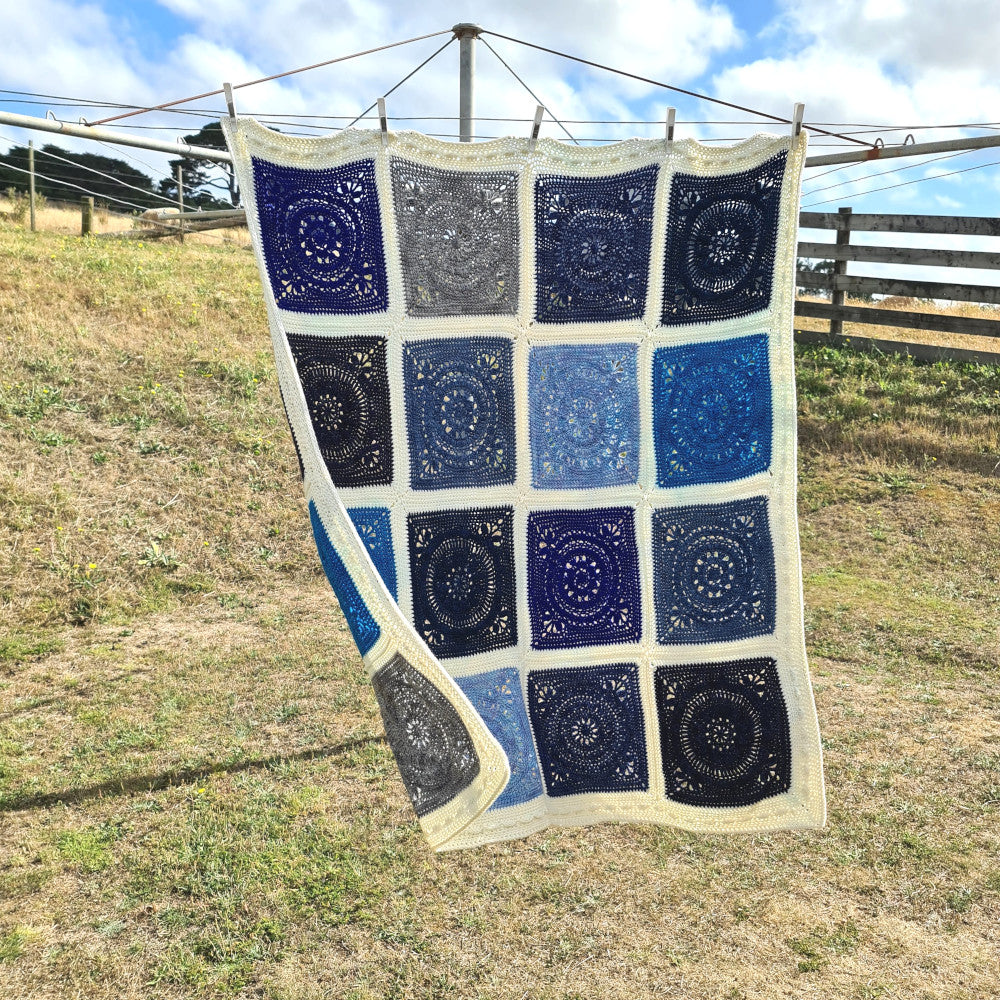 Oceanic blanket hanging on clothes line 