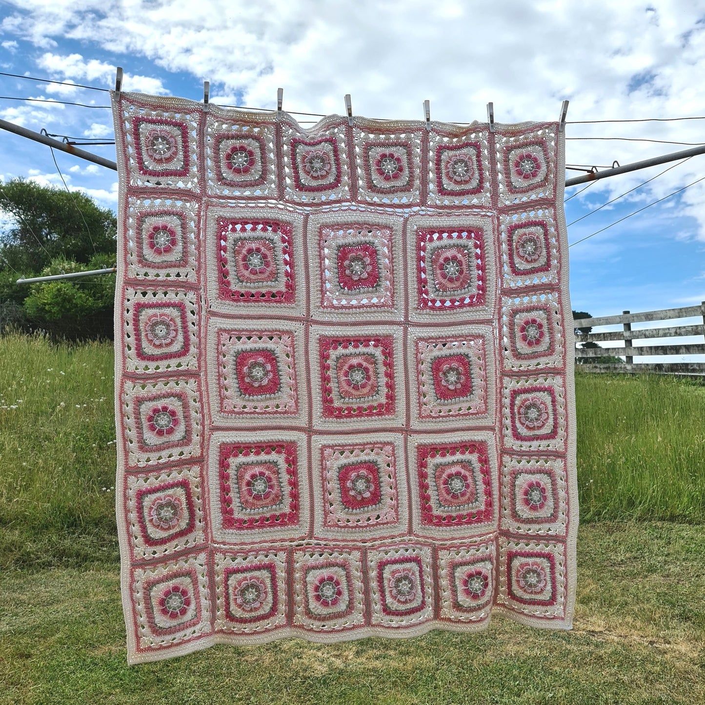 Persnickety Blanket crochet pattern by Shelley Husband hanging from a clothes line with a paddock in the background