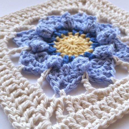 Close up of cream, blue and yellow granny square of Pinkie granny square pattern by Shelley Husband