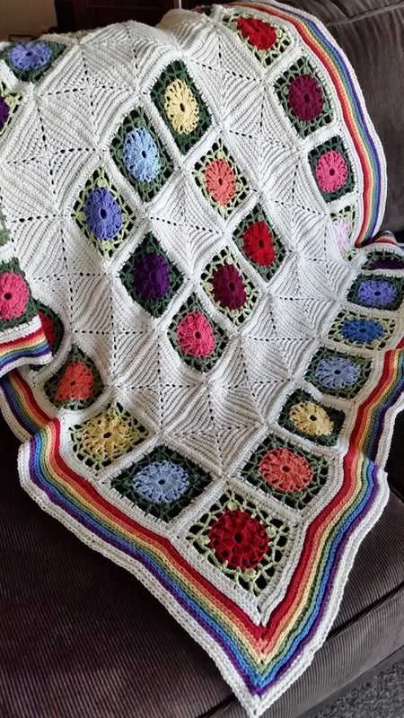 Posies and Pickets Blanket Pattern by Shelley Husband over a couch