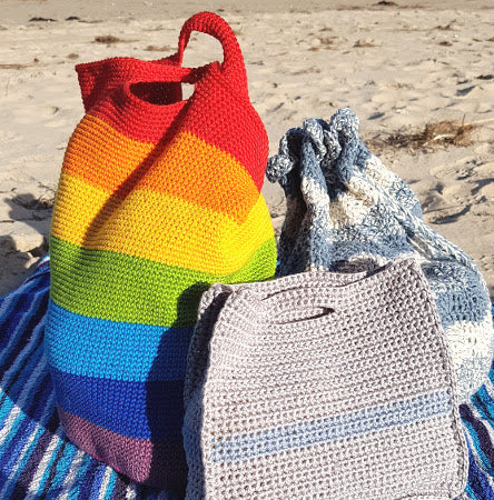 Swell, Spectrum and Slipstream bags from theProject Bags Bundle by Shelley Husband on a towel on the beach