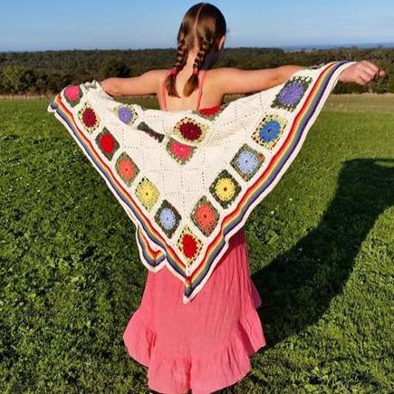 Posies and Pickets Blanket Pattern by Shelley Husband worn like a cape by a child