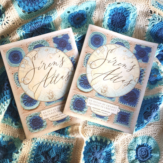 Siren's Atlas books by Shelley Husband on a Siren's Atlas sampler blanket