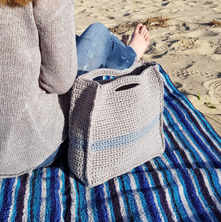 Slipstream bag from Project Bags Bundle by Shelley Husband on a towel next to a woman on the sand at the beach