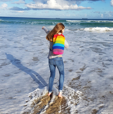 Woman in waves holding Spectrum Project Bag by Shelley Husband