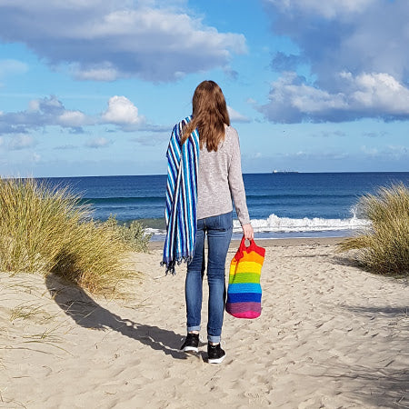Woman on beach holding Spectrum Project Bag by Shelley Husband