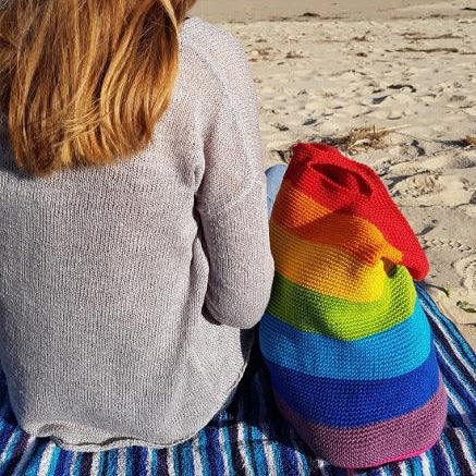 Woman on beach next to Spectrum Project Bag by Shelley Husband