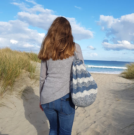 Woman holding Swell Project Bag Pattern by Shelley Husband at the beach