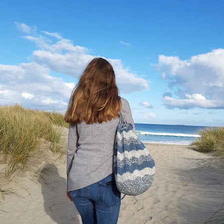 Woman holding Swell Project Bag Pattern by Shelley Husband at beach