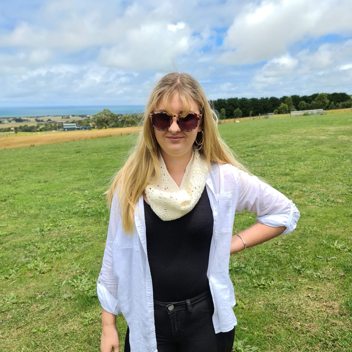 Aurora Cowl by Shelley Husband worn by a blonde woman in a paddock