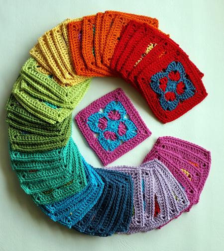 Groovin' Blanket granny squares in a semi circle in a rainbow of colours by Shelley Husband